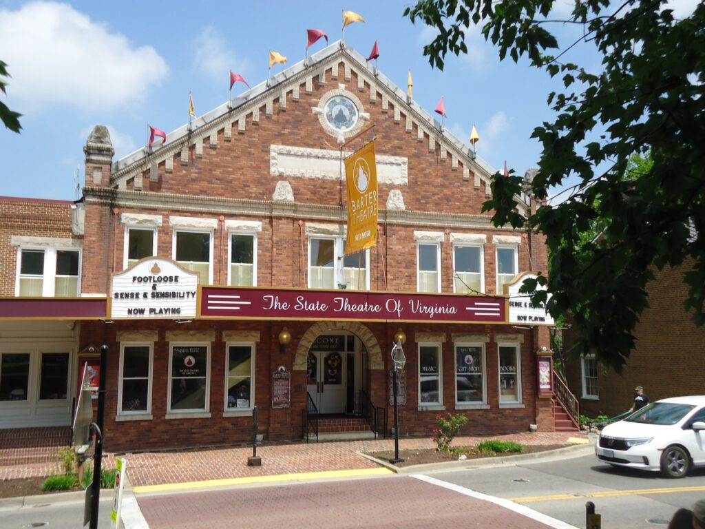 An exterior shot of the Barter Theater, the state theatre of Virginia. A marquee reads Footloose and Sense & Sensibility playing now.