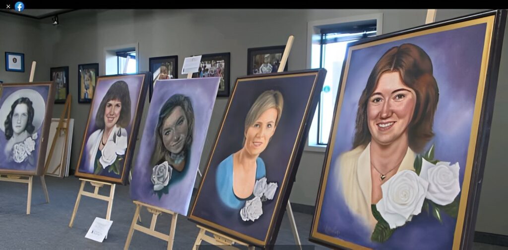 Five paintings of smiling women hang on easels in a large room. Each woman has white roses in front of them.