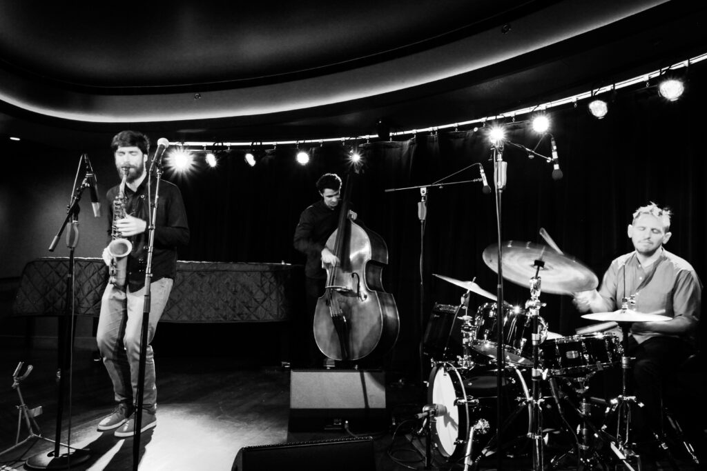 A black and white photo of a trio Jazz Ensemble performing