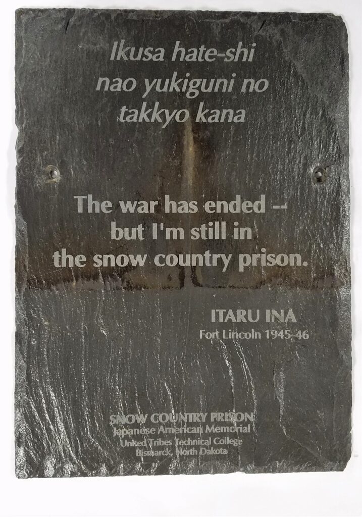 A slate roof tile engraved with a haiku