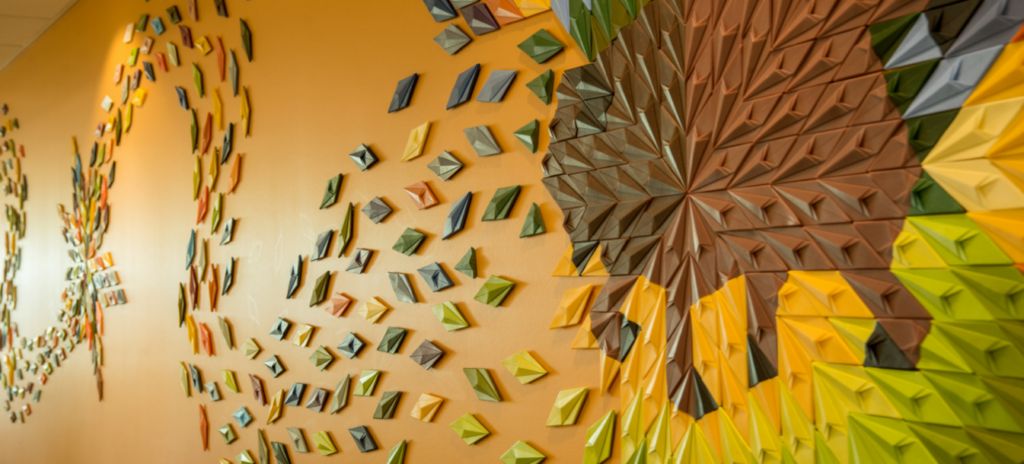 An art piece on an orange wall depicts a buffalo.