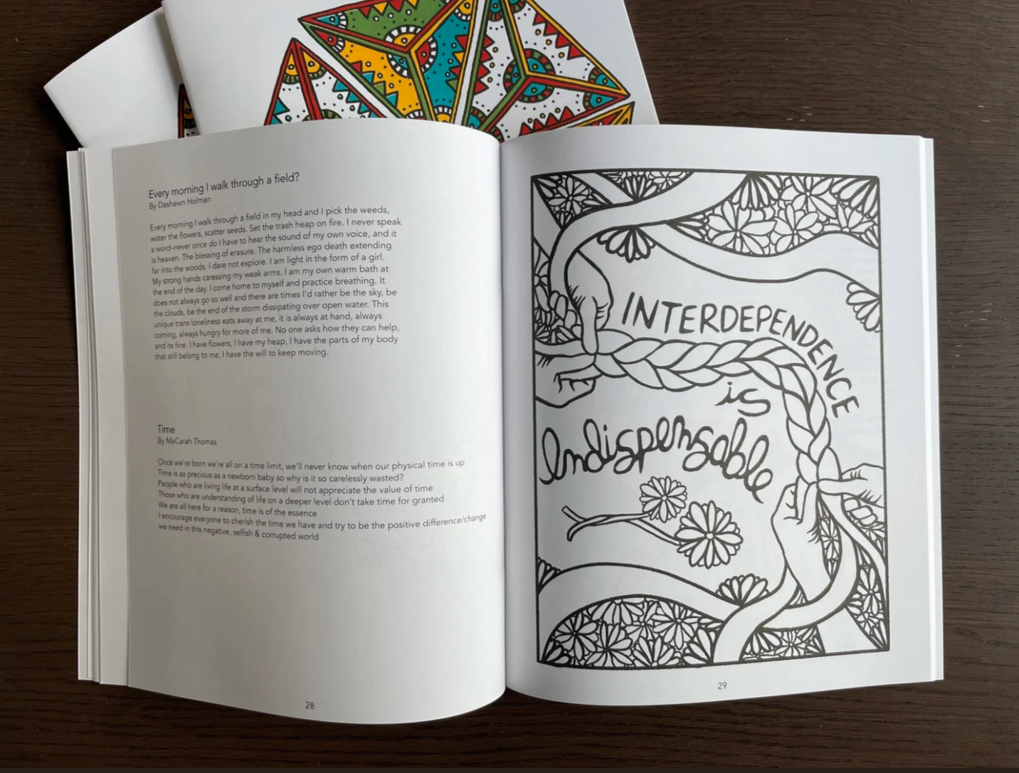 An open book with writing and a full-page black-and-white illustration.